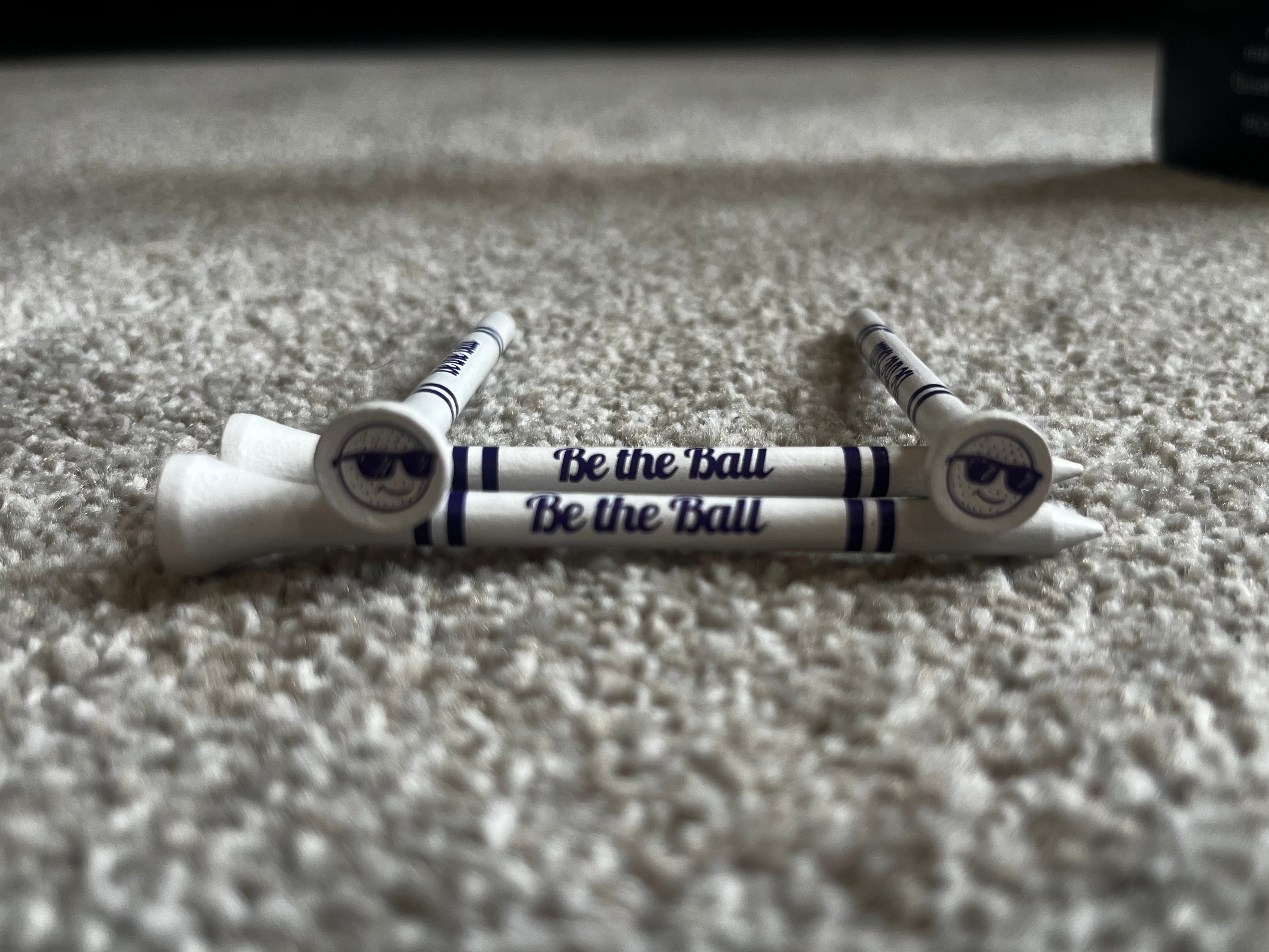 "Be the Ball" name printed on golf tees, with 4 stripes. Along with "Be the Ball" Logo printed on the cup of the tee.